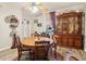 This dining room showcases a round wooden table, hardwood floors, and a vintage china cabinet at 1610 Elm Ne St, Conyers, GA 30012