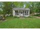 Charming home featuring a screened porch, small fire pit and lush greenery at 1610 Elm Ne St, Conyers, GA 30012