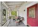 A well lit porch features decorative glass, seating and views of the front yard at 1610 Elm Ne St, Conyers, GA 30012