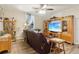 Bright living room featuring a leather sofa, ceiling fan, and natural lighting at 1610 Elm Ne St, Conyers, GA 30012