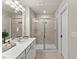 Bathroom featuring a shower with glass doors and neutral-toned tiling at 2452 Coosa Vly, Atlanta, GA 30339