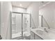 Bright bathroom featuring a vanity with a sink, toilet, and a glass-enclosed shower at 2452 Coosa Vly, Atlanta, GA 30339