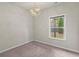 Bedroom with a modern light fixture and a window providing natural light, offering a cozy and inviting space at 2452 Coosa Vly, Atlanta, GA 30339