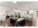 Open concept kitchen and dining space with a large island, modern lighting, and hardwood floors at 2452 Coosa Vly, Atlanta, GA 30339