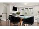 Modern dining area featuring a glass table, velvet chairs, and views of a bright living space at 2452 Coosa Vly, Atlanta, GA 30339