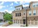 Charming exterior elevation of home with a two-car garage and manicured lawn at 2452 Coosa Vly, Atlanta, GA 30339