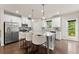 Bright kitchen with a large island, stainless steel appliances, white cabinets, and wood floors at 2452 Coosa Vly, Atlanta, GA 30339