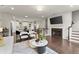 Open concept living room with a fireplace, kitchen, and adjacent dining space at 2452 Coosa Vly, Atlanta, GA 30339