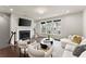 Comfortable living room featuring a fireplace, large windows, and a cozy seating area at 2452 Coosa Vly, Atlanta, GA 30339