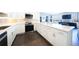 Modern kitchen with sleek white cabinets, marble countertops, and dark hardwood floors at 75 14Th Ne St # 3820, Atlanta, GA 30309