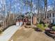 An eye-level side view of a red brick two-story home showing a gently sloping front yard at 1008 Poplar Grv, Woodstock, GA 30189