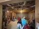 Unfinished basement featuring exposed ceiling, concrete walls, and storage containers at 3740 Tupelo Trl, Auburn, GA 30011