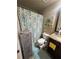 Compact bathroom with a shower, toilet, sink, and vanity; blue and white accents give it a clean look at 3740 Tupelo Trl, Auburn, GA 30011