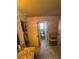 Neutral bathroom with a tiled floor, white toilet, floral wallpaper, and white doors at 3740 Tupelo Trl, Auburn, GA 30011