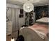 Comfortable bedroom with a white bed, stylish lighting, and decorative wall hangings at 3740 Tupelo Trl, Auburn, GA 30011