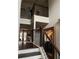 Entryway showcasing stairs with iron railings and a large mirror, and hardwood floors at 3740 Tupelo Trl, Auburn, GA 30011