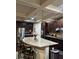 Bright kitchen with stainless steel appliances, a large granite island, and dark wood cabinetry at 3740 Tupelo Trl, Auburn, GA 30011