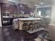 Kitchen features a center island with bar stool seating, granite counters, and stainless steel appliances at 3740 Tupelo Trl, Auburn, GA 30011