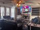 Comfortable living room with a stone fireplace, built-in shelves, and plush leather seating at 3740 Tupelo Trl, Auburn, GA 30011