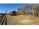 Expansive grassy lot with trees and neighborhood houses at 3740 Tupelo Trl, Auburn, GA 30011