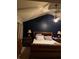 Cozy bedroom with dark blue accent wall and vaulted ceiling complemented by a comfortable bed and lamps at 3740 Tupelo Trl, Auburn, GA 30011