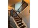 Staircase with decorative wallpaper and dark brown railings at 3740 Tupelo Trl, Auburn, GA 30011