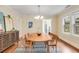 Bright dining room featuring hardwood floors, a modern chandelier, and ample seating at 1626 Rogers Sw Ave, Atlanta, GA 30310