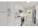 A well-organized kitchen featuring white cabinets, stainless steel appliances, and modern countertops at 1626 Rogers Sw Ave, Atlanta, GA 30310