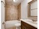 Cozy bathroom featuring a bathtub with tile surround and a vanity with marble countertop at 2930 Torreya Se Way, Marietta, GA 30067
