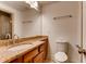 Bathroom featuring granite countertops, wood cabinets, toilet and large mirror above sink area at 2930 Torreya Se Way, Marietta, GA 30067