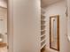 A well-organized walk-in closet with shelving and hanging rods, along with a full length mirror at 2930 Torreya Se Way, Marietta, GA 30067