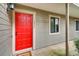 Front entrance has a bright red door on a gray-sided unit with manicured landscaping at 2930 Torreya Se Way, Marietta, GA 30067