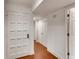 Hallway with wood floors features doors, closets, and modern trim with neutral paint at 2930 Torreya Se Way, Marietta, GA 30067