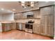 Kitchen features gray cabinets, stainless steel appliances, warm countertops and wood flooring at 2930 Torreya Se Way, Marietta, GA 30067