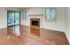 Bright living room with fireplace, wood floors, and sliding glass doors to backyard at 2930 Torreya Se Way, Marietta, GA 30067