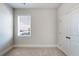 This bedroom features neutral walls, carpet, and a bright window at 5255 Austrian Pine Ct, Cumming, GA 30040