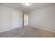 Neutral bedroom with gray carpeting, fresh gray paint, and a door leading to another room at 5255 Austrian Pine Ct, Cumming, GA 30040