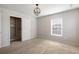 Cozy bedroom with neutral walls, carpeted floors, and a closet with shelving for ample storage at 5255 Austrian Pine Ct, Cumming, GA 30040
