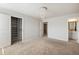 Spacious bedroom features neutral carpeting, chandelier light fixture, and an ensuite bathroom at 5255 Austrian Pine Ct, Cumming, GA 30040