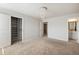 Spacious bedroom featuring an attached bathroom, a walk-in closet, and an elegant decorative ceiling light at 5255 Austrian Pine Ct, Cumming, GA 30040