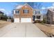 Charming two-story home with a brick facade, manicured lawn, and a spacious two-car garage at 5255 Austrian Pine Ct, Cumming, GA 30040