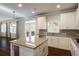 Bright kitchen features granite countertops, white cabinets, stainless steel appliances, and an island for extra space at 5255 Austrian Pine Ct, Cumming, GA 30040