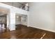 Open-concept living room with hardwood floors, grand windows, high ceilings, and elegant chandelier at 5255 Austrian Pine Ct, Cumming, GA 30040