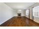 Spacious living room featuring hardwood floors, a fireplace, and built-in shelving at 5255 Austrian Pine Ct, Cumming, GA 30040