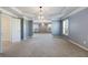 Spacious main bedroom features large windows, a tray ceiling, chandelier, carpet, and neutral walls at 5255 Austrian Pine Ct, Cumming, GA 30040