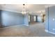 Large primary bedroom with tray ceiling, decorative lighting, carpet, and natural light from multiple windows at 5255 Austrian Pine Ct, Cumming, GA 30040