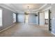 Elegant main bedroom with tray ceiling, chandelier, neutral paint, large windows, carpet, and lots of space at 5255 Austrian Pine Ct, Cumming, GA 30040