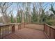 Back deck featuring a wood railing and views of the trees at 1322 Lorenzo Sw Dr, Atlanta, GA 30310