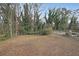 Large, grassy backyard area surrounded by mature trees and a chain-link fence, providing ample space at 1322 Lorenzo Sw Dr, Atlanta, GA 30310