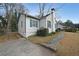 Exterior view of a charming home featuring white siding, blue trim, and a stone pathway at 1322 Lorenzo Sw Dr, Atlanta, GA 30310